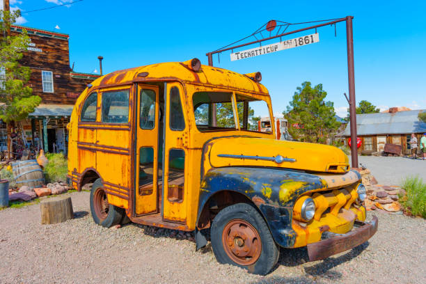 An abstract view of the windows in the side of an abandoned yellow school bus.
