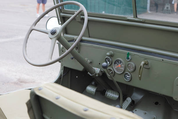 United States Army Second World War Jeep Driver's Seat and Controls Featuring 4 wheel drive, a 4 speed transmission and simple design, the Willys Jeep was easy to build, easy to maintain, and used by all the allied forces all over the world. This is a view of the driver’s seat and controls, showing how basic the construction was.
This image was taken at an outdoor event over the weekend of 25th June 2023, where reenactors, living historians, and members of the public can come to experience what life was like during the second world war, with live demonstrations, battle reenactments, and static displays from all over the world. jeep 4x4 off road vehicle world war ii stock pictures, royalty-free photos & images