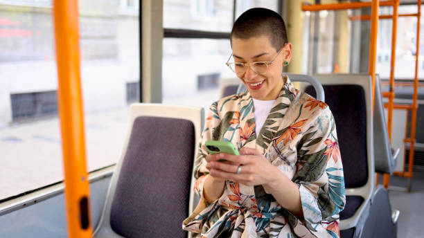 istock Beautiful short-haired girl using smartphone during a bus ride 2155131528