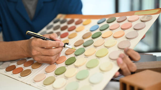 istock Male interior designer expert showing color palette while helping client for home renovation project 2155134011