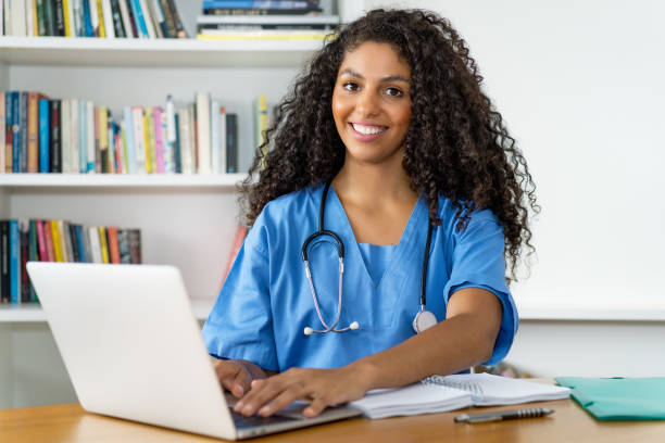 istock Mexican female nurse at computer at office 2155135304