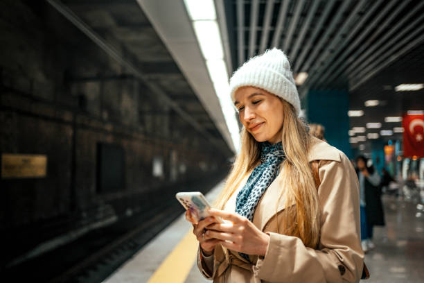 istock Woman using phone in a subway station 2155135715