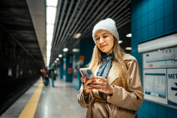istock Woman using phone in a subway station 2155135737
