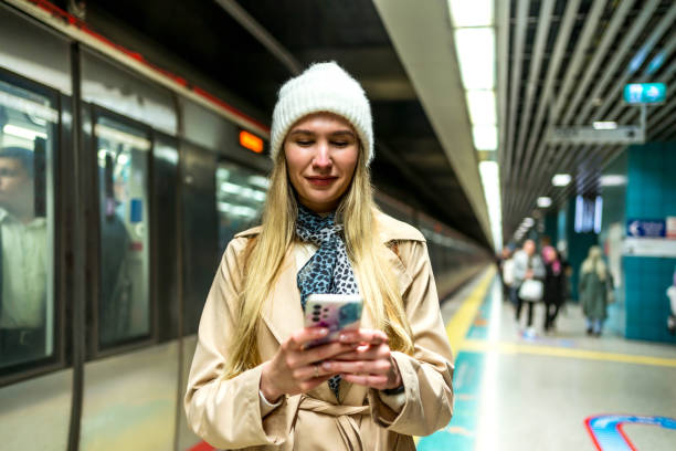 istock Woman using phone in a subway station 2155136265