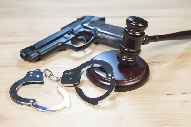 istock Judge Hammer for adjudication with handcuff and gun. 2155136344