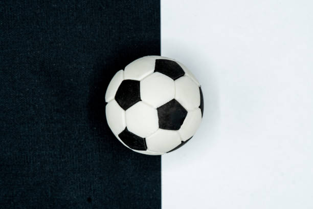 istock Black and white soccer ball on black and white background. Top view 2155136435