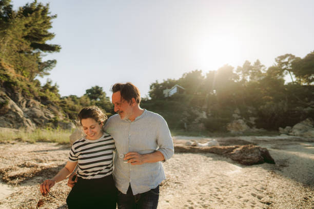 istock Smiling couple on a date by the sea 2155136506