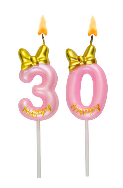 istock Pink birthday candles with bow isolated on white. Number 30. 2155138256
