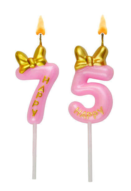istock Pink birthday candles isolated on white. Number 75. 2155138300