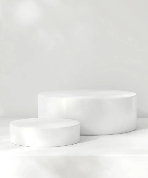 istock Two white podium on counter, soft beautiful dappled sunlight, leaf shadow on wall 2155141765
