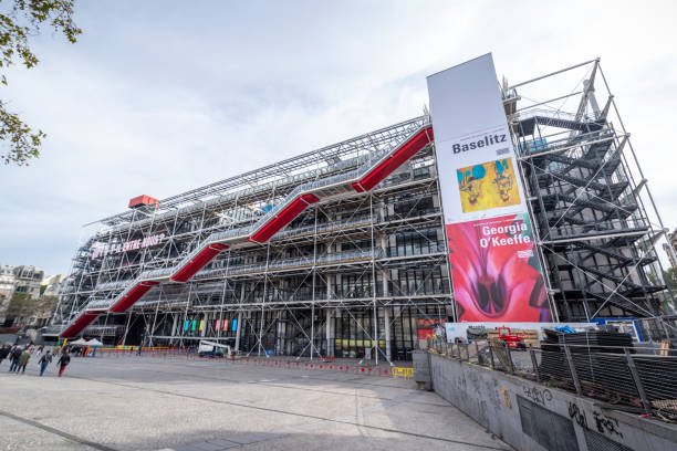 October 18, 2021 - Paris, France: The vibrant colors and exposed structural elements of the Centre Pompidou create a striking façade, while tourists walk in front, admiring the visual spectacle.