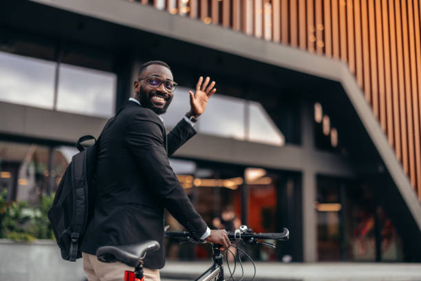 istock Handsome afro businessman with bike 2155146002