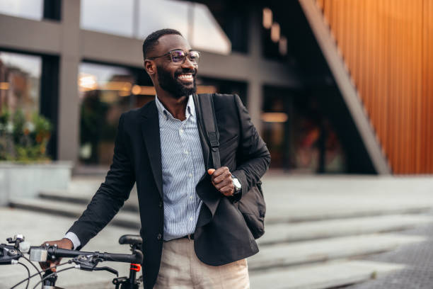 istock Handsome afro businessman with bike 2155146033