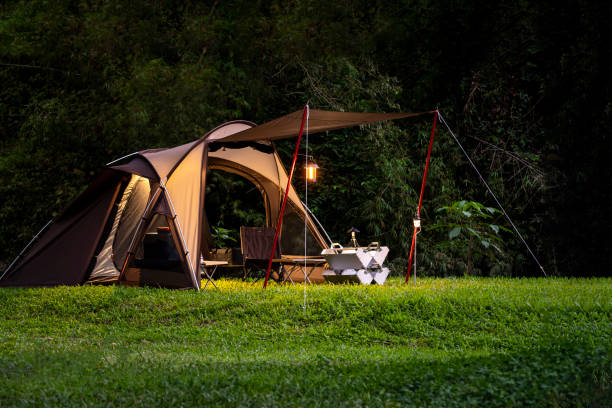 Set up a tent in the dusk at campground