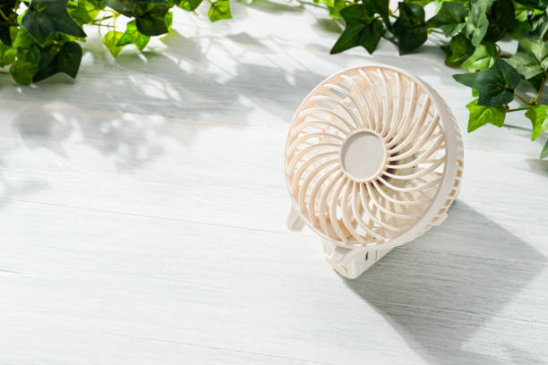 istock Portable electric fan on wooden table 2155148672