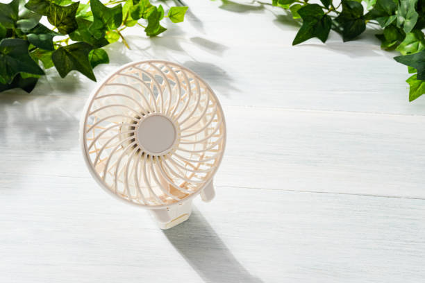 istock Portable electric fan on wooden table 2155148680