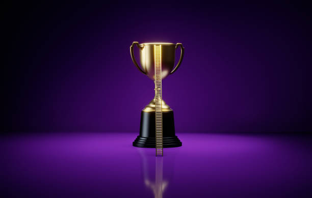istock Gold Colored Ladder Leaning Onto A Gold Trophy On Purple Background 2155149961
