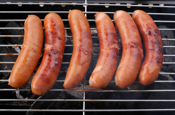 istock Sausages on barbeque grill close up. 2155151295