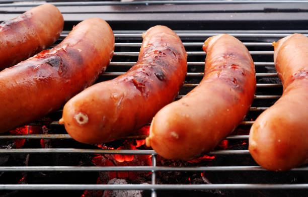 istock Sausages on barbeque grill close up. 2155151355