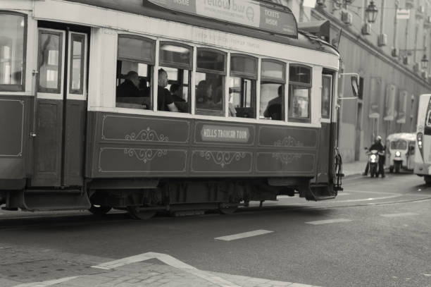 Lisbon, Portugal - November 11, 2023: A traditional old tram runs along a street in Lisbon downtown.