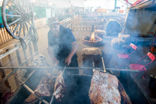Caxias do Sul, RS, Brazil - Sep 16th, 2022: Gaucho making a churrasco (barbecue) at Acampamento Farroupilha (Farroupilha Camp)