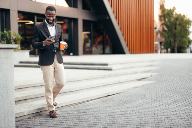 istock Businessman using phone outside the office 2155154943