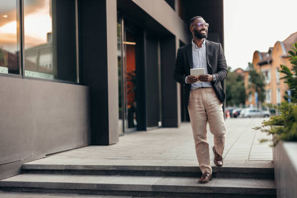 istock Portrait of businessman using digital tablet outside the office. 2155155739