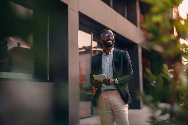 Portrait of businessman using digital tablet outside the office.