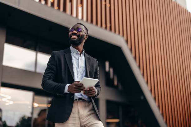 istock Portrait of businessman using digital tablet outside the office. 2155155745