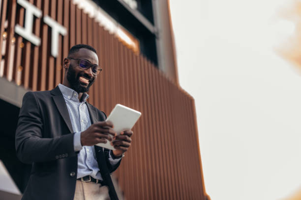 istock Portrait of businessman using digital tablet outside the office. 2155155747