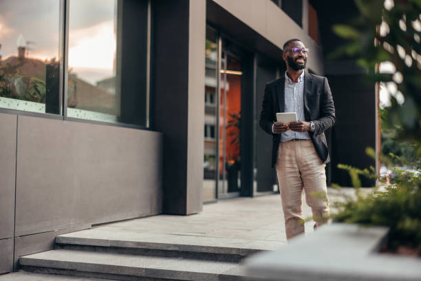 istock Portrait of businessman using digital tablet outside the office. 2155155749