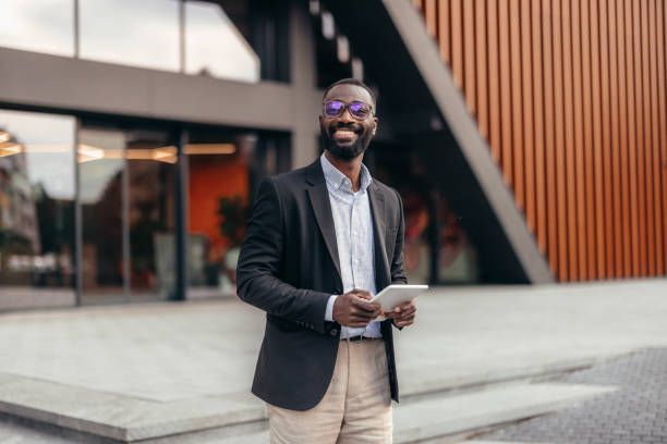 istock Portrait of businessman using digital tablet outside the office. 2155155750