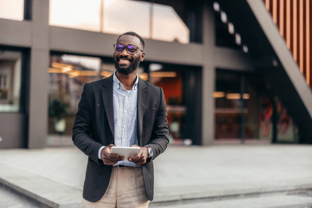 istock Portrait of businessman using digital tablet outside the office. 2155155751