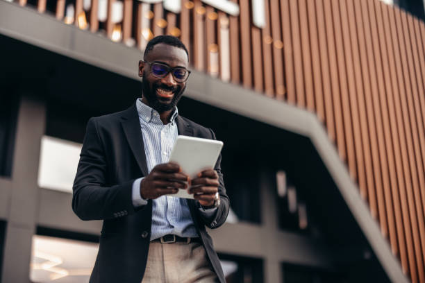 istock Portrait of businessman using digital tablet outside the office. 2155155756