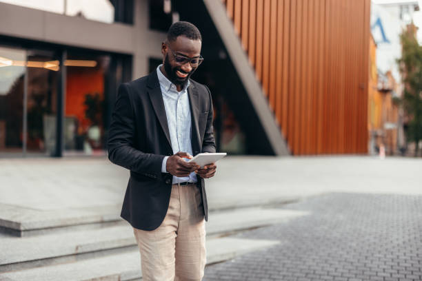 istock Portrait of businessman using digital tablet outside the office. 2155155762