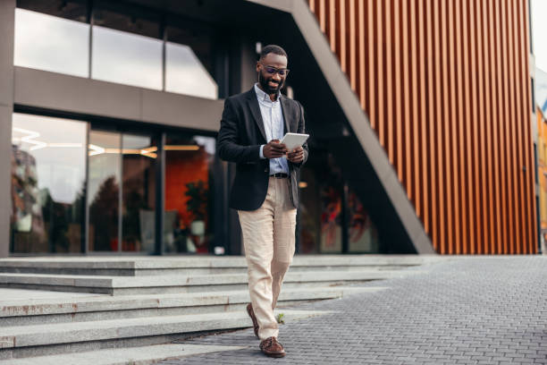 istock Portrait of businessman using digital tablet outside the office. 2155155763