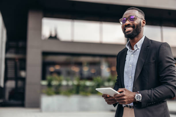 istock Portrait of businessman using digital tablet outside the office. 2155155764
