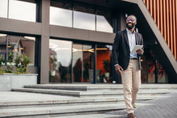 istock Portrait of businessman using digital tablet outside the office. 2155155768