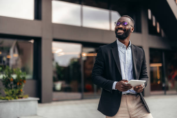istock Portrait of businessman using digital tablet outside the office. 2155155773