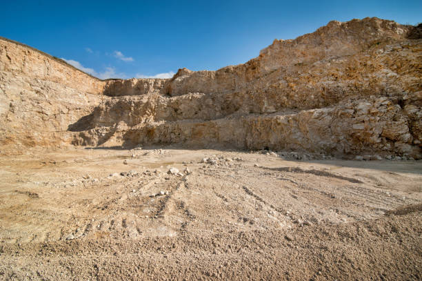 Panorama of the quarry on stone layers and blue sky. Mining of decorative and building stone, limestone, gypsum by open method