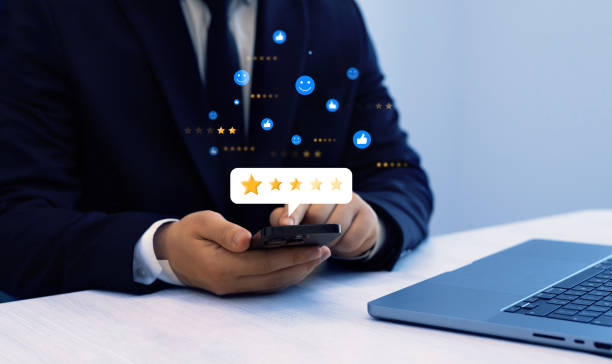 istock Satisfaction, quality and performance.Businessman gives leave feedback on the bought product with five star rating. Review customer satisfaction feedback. 2155160528