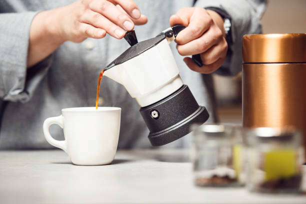 istock Preparing Fresh Cup of Coffee With Classic Italian Moka Pot in Modern Kitchen 2155168685
