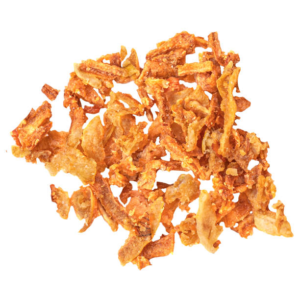 istock Crispy fried onion flakes  isolated on white background. Crunchy Scattered Dry Onion Pieces close up 2155170459