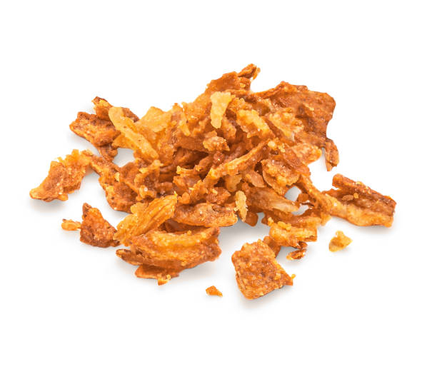 istock Crispy fried onion flakes  isolated on white background. Crunchy Scattered Dry Onion Pieces close up 2155170504