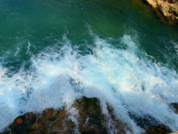 istock Close-up of Green Water Stream and Stones 2155171937