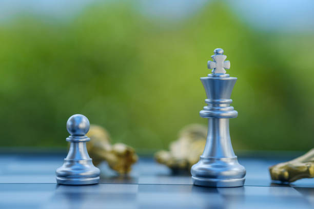 istock gold  knight Against whithe background, International chess, ideas and competition and strategy, chess board game competition business concept. 2155176329