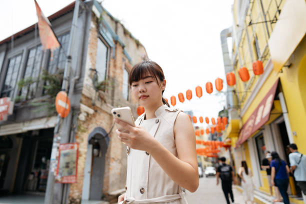 istock Young Asian woman using smartphone while traveling 2155177213