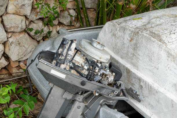 Weathered base of a rowboat and an old out board motor.