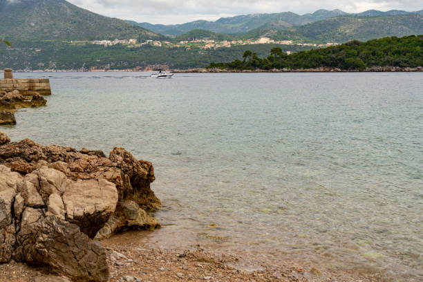 The harbour at Kolocep Island, Croatia.  In the background is a motorboat coming into the harbour.