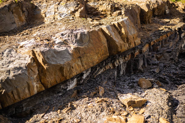 Old Aged Shabby Cliff Face And Divided By Huge Cracks And Layers